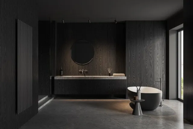 Bathroom with dark wood-panel walls, a floating vanity, and a grey freestanding tub